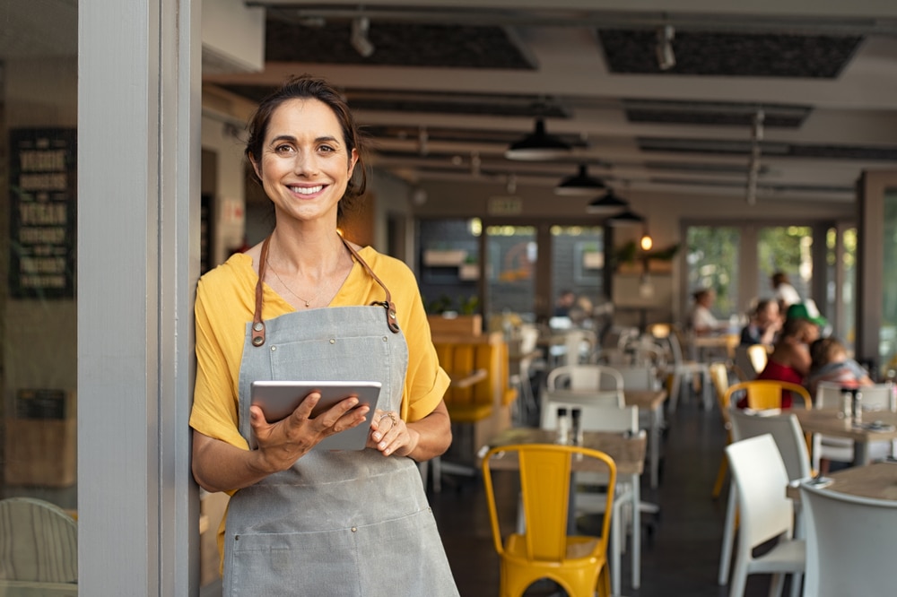 Anchorage small business owner with tablet that runs her payment processing service