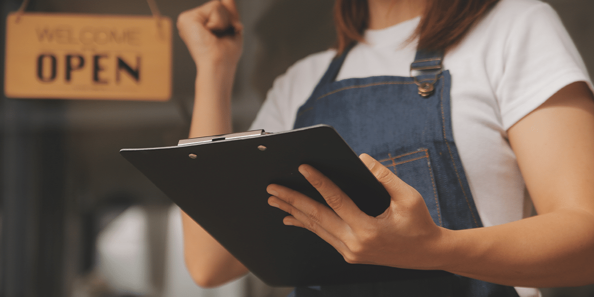 Restaurant server holding clipboard.