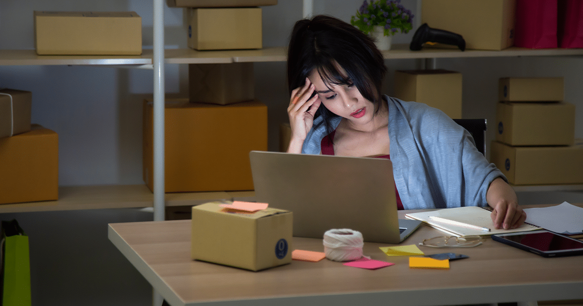 woman stressed at computer due to outdated payment systems