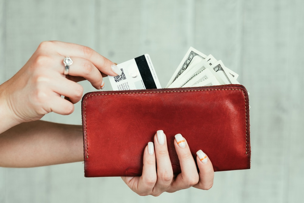 Person taking credit card out to engage in credit card processing