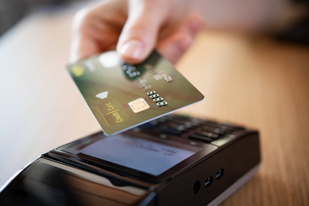 Person putting their credit card in a emv compliant pos system