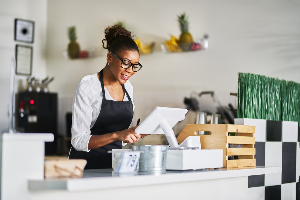 Woman uses her restaurant Clover POS system