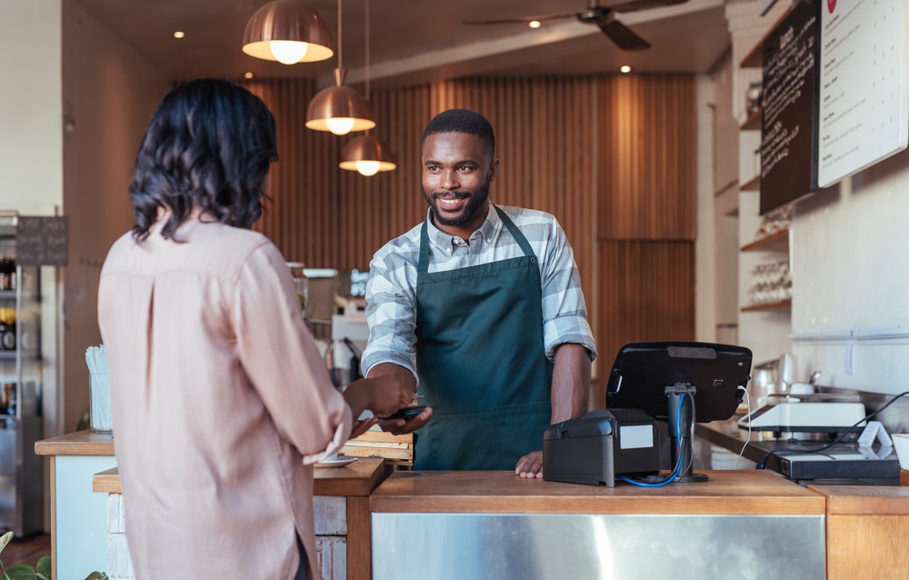 man cashing out customer